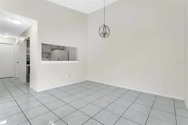 an empty room with windows and painted walls