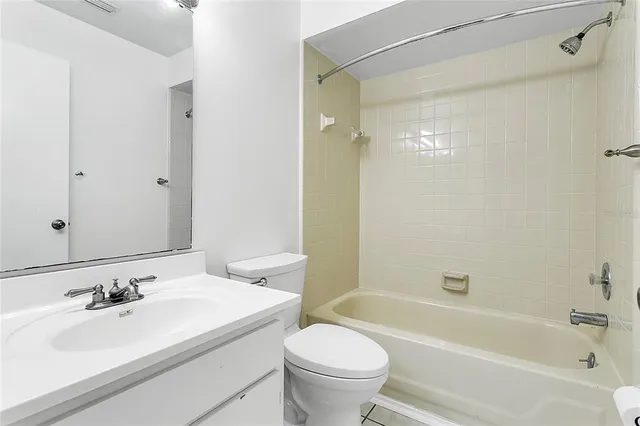 a bathroom with a sink toilet tub and shower