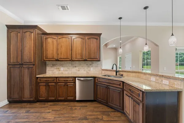 a bathroom with a granite countertop sink toilet a mirror and shower