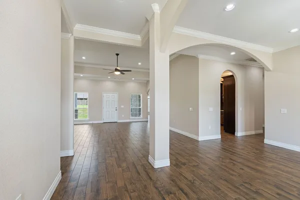 a kitchen with stainless steel appliances granite countertop wooden cabinets a sink and dishwasher a stove top oven with wooden floor