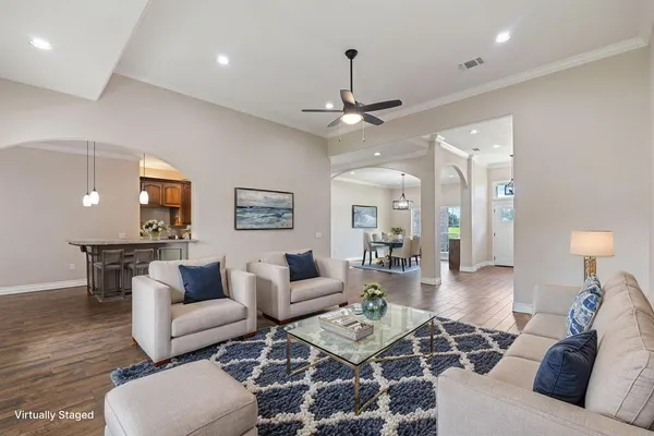 a living room with furniture a fireplace and a flat screen tv