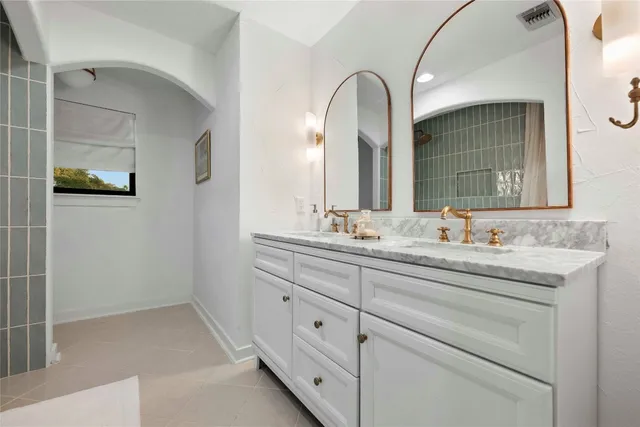 a bathroom with a double vanity sink and mirror