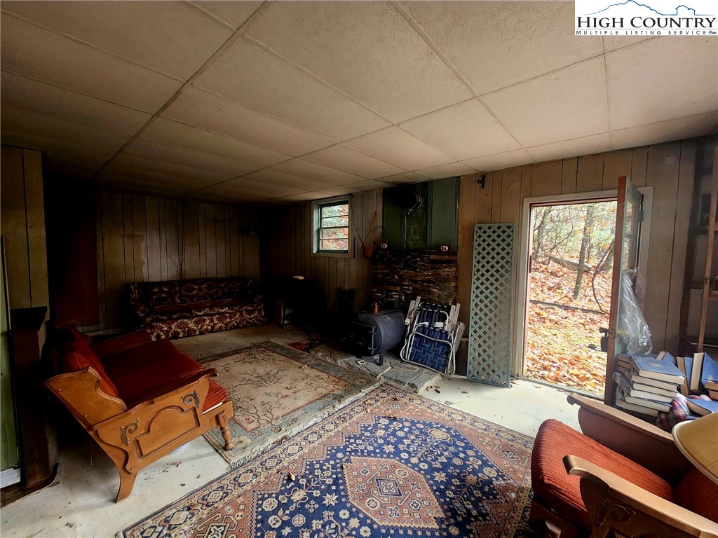 2876 Howard's Creek Road Boone, NC 28607 - Photo 12 of 34 a living room with furniture a flat screen tv and a window