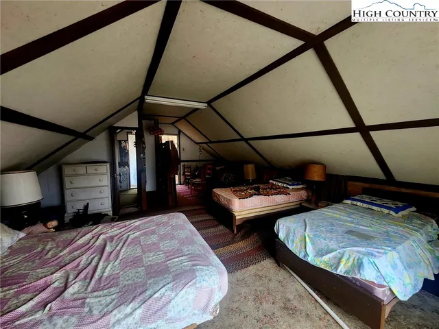 a view of a bedroom with furniture