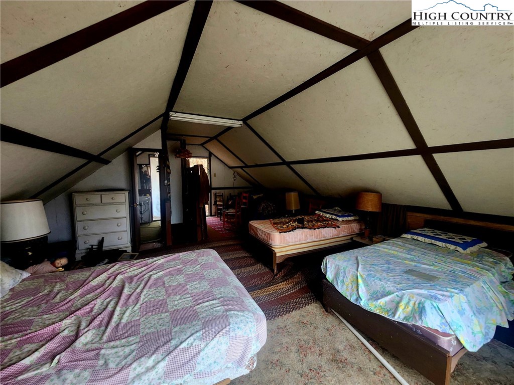 2876 Howard's Creek Road Boone, NC 28607 - Photo 13 of 34 a view of a bedroom with furniture