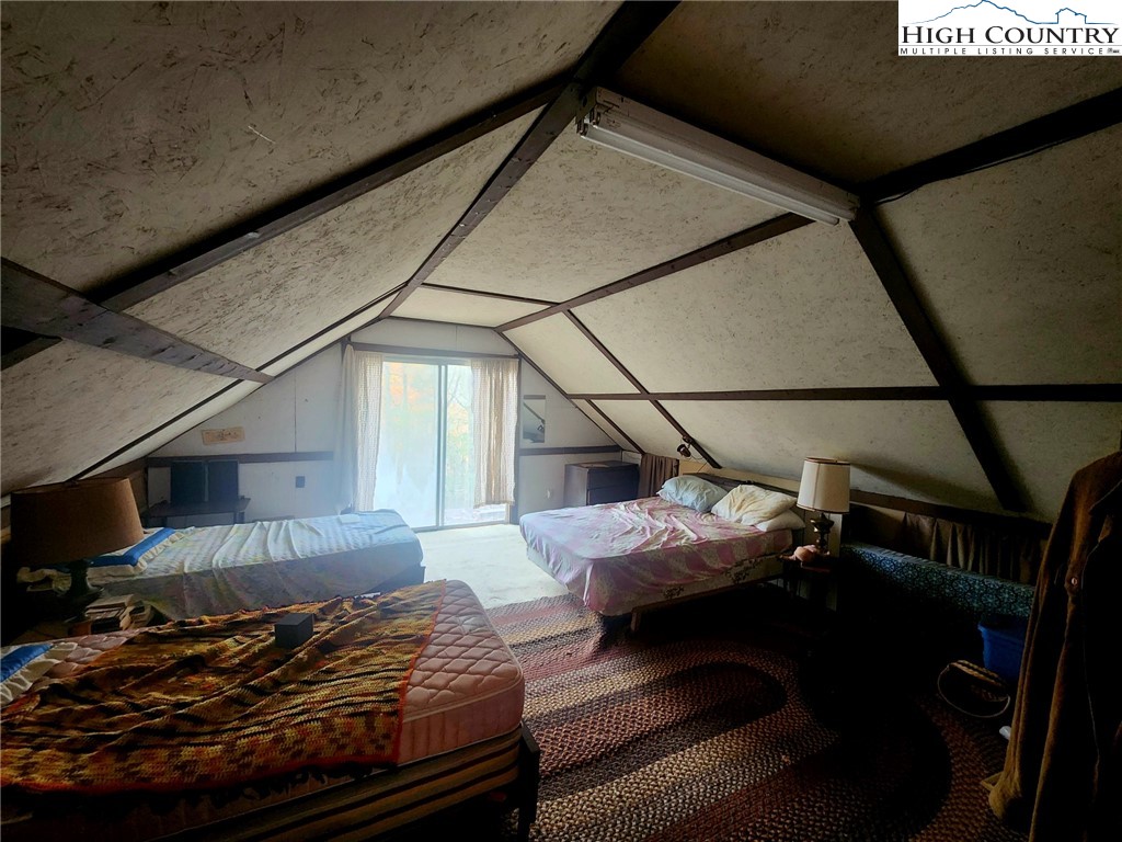 2876 Howard's Creek Road Boone, NC 28607 - Photo 14 of 34 a bedroom with bed and balcony