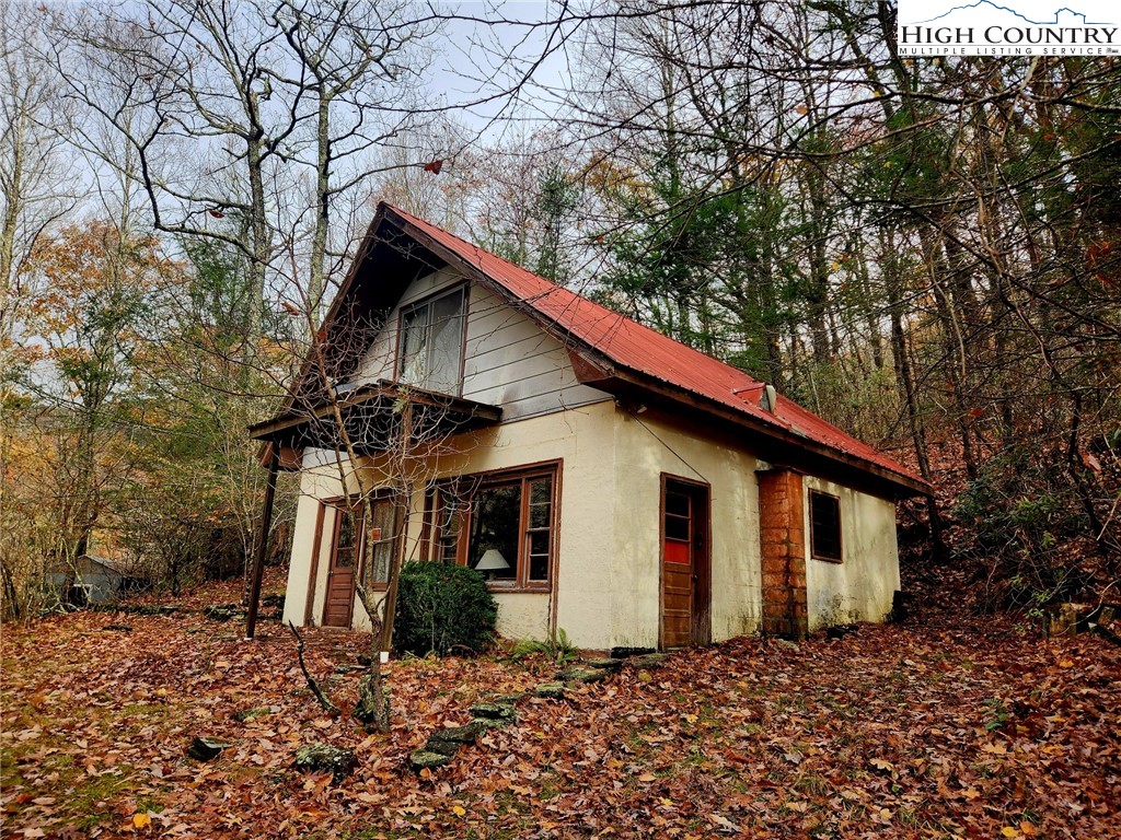 2876 Howard's Creek Road Boone, NC 28607 - Photo 2 of 34 a view of a house with a yard