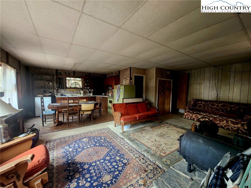 2876 Howard's Creek Road Boone, NC 28607 - Photo 10 of 34 a living room with furniture and a fireplace