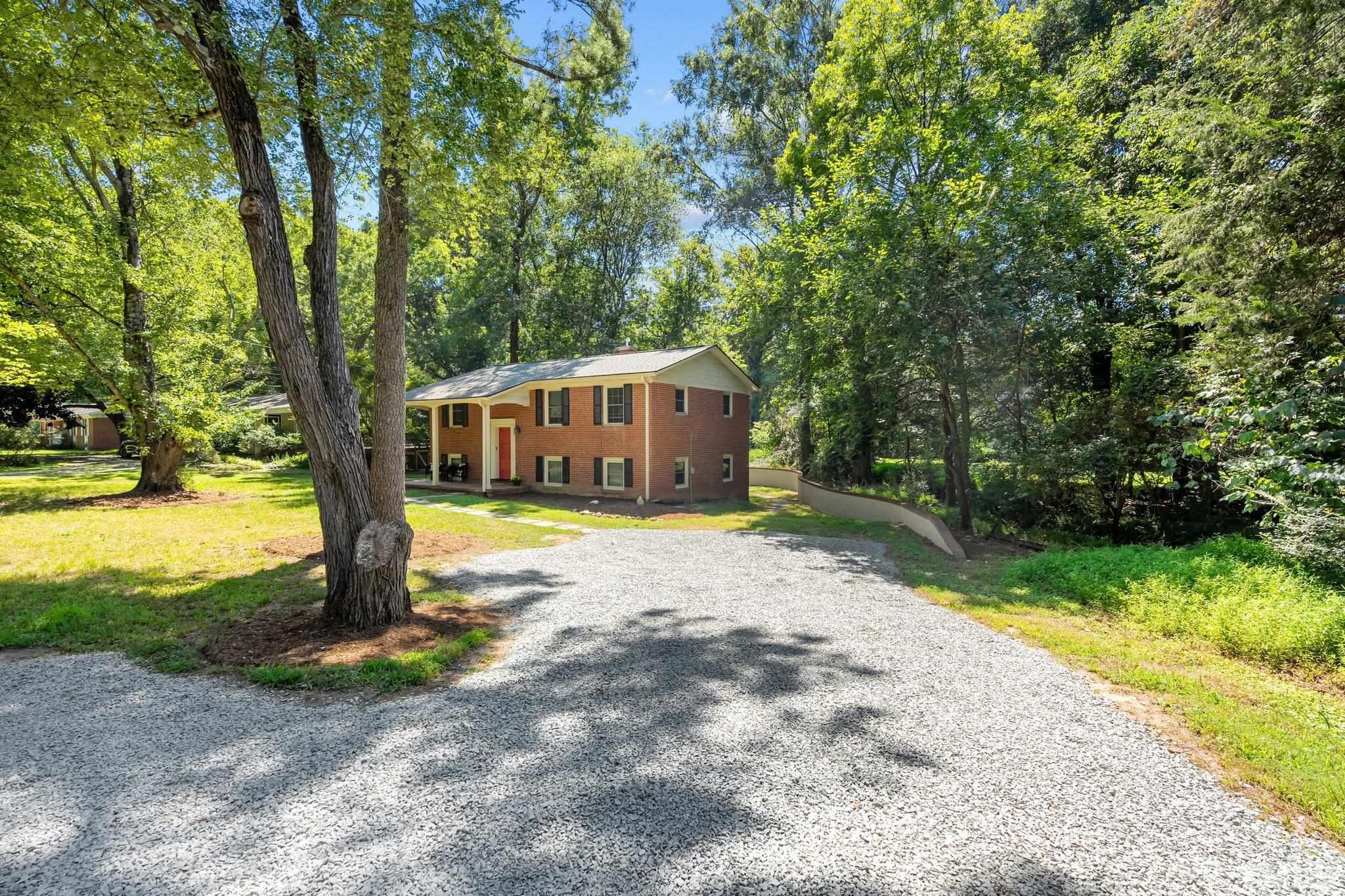 1305 West Main Street Carrboro, NC 27510 - Photo 1 of 31 a house with trees in the background