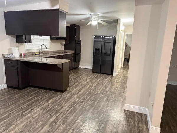 a room with a bed and a mirror on the dresser