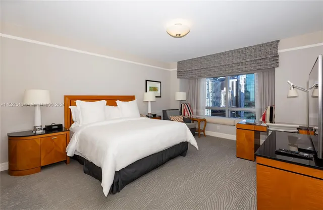 a bedroom with bed couch and window