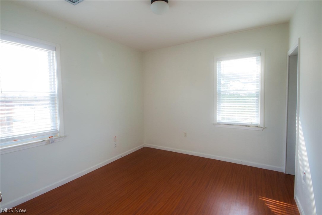 6311 Ridge Road Parma, OH 44129 - Photo 12 of 26 Spare room featuring a wealth of natural light and dark hardwood / wood-style floors