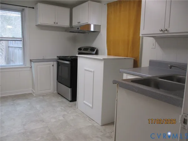a kitchen with a sink and cabinets