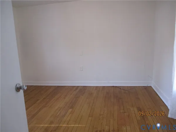 a view of a room with wooden floor
