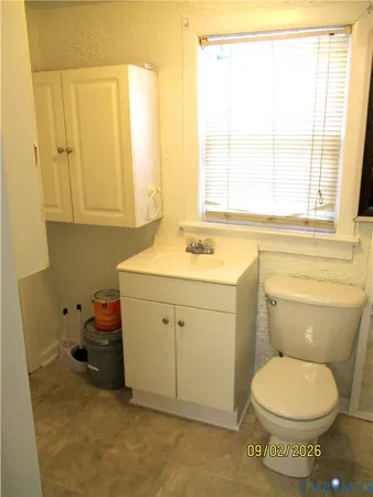 a bathroom with a sink toilet vanity and tub