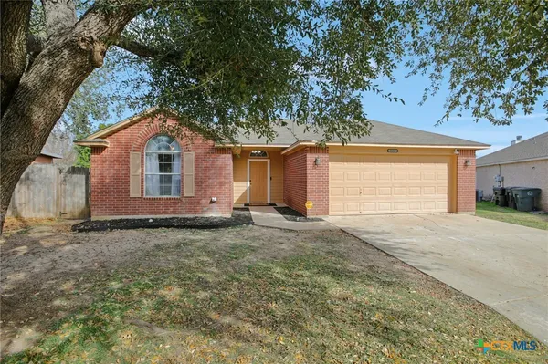 a view of a house with a yard and garage