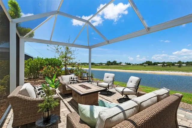 a roof deck with a table and chairs under an umbrella