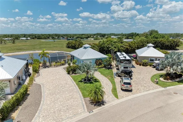 an aerial view of a house with garden space and outdoor seating