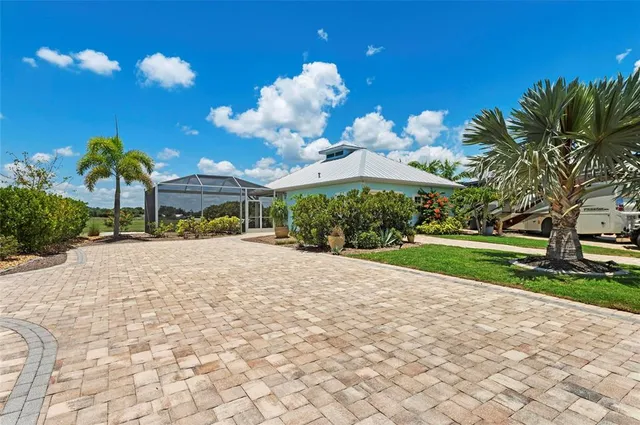 a view of a house with a yard and a garage