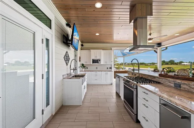 a kitchen with stainless steel appliances granite countertop a sink and a stove