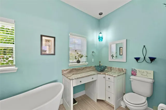 a bathroom with a sink a toilet and mirror