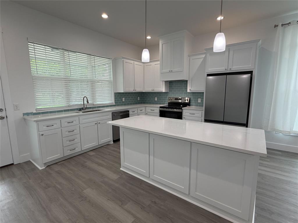 4200 Williams Road Bellmead, TX 76705 - Photo 5 of 22 a kitchen with a sink a window stainless steel appliances and cabinets