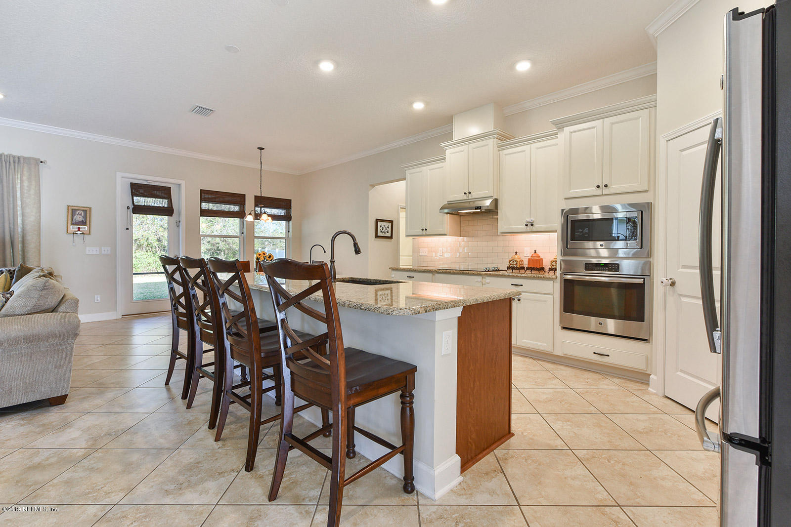 16396 Tisons Bluff Road Jacksonville, FL 32218 - Photo 11 of 30 a kitchen with stainless steel appliances granite countertop a stove a sink a microwave oven and a refrigerator