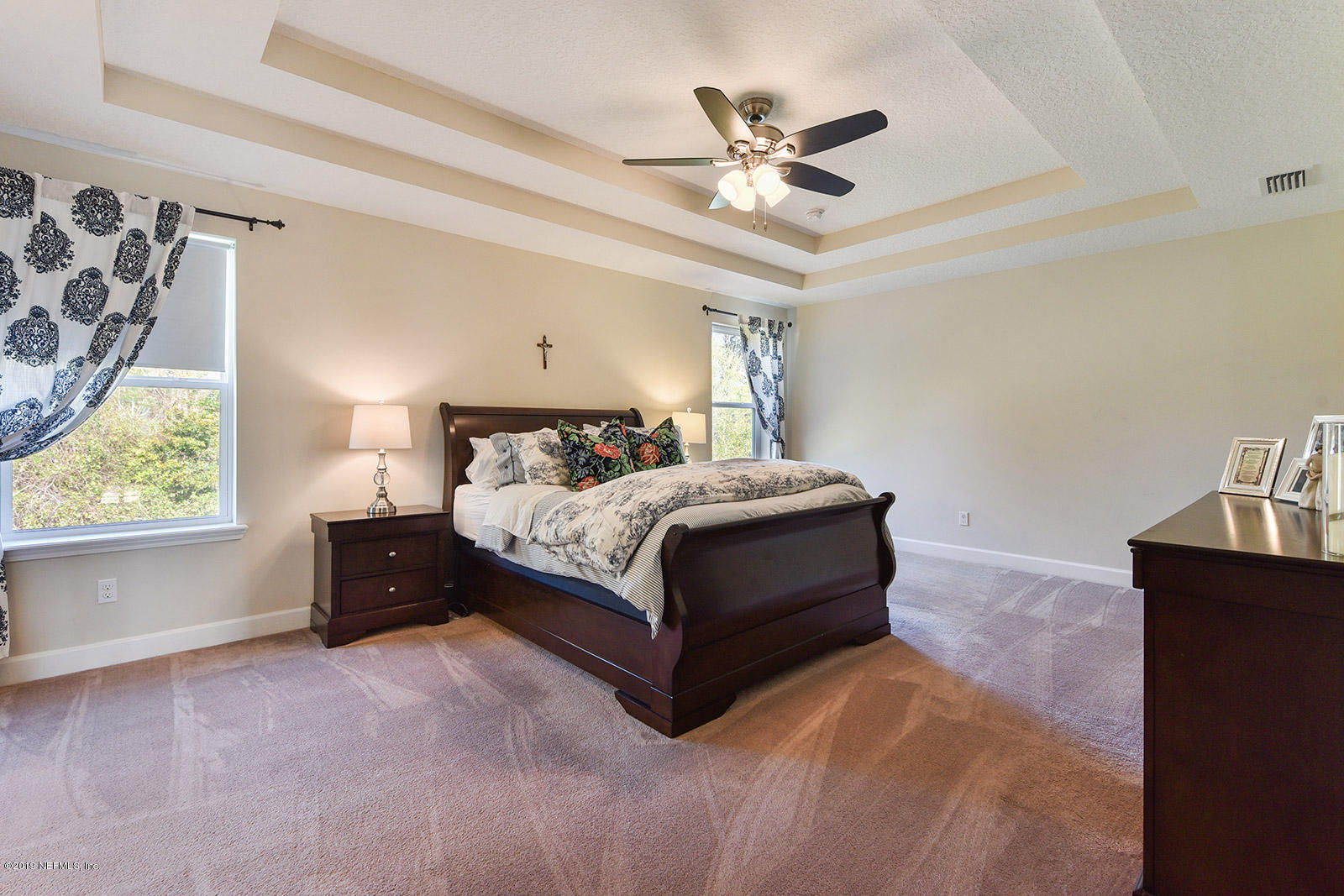 16396 Tisons Bluff Road Jacksonville, FL 32218 - Photo 19 of 30 a bedroom with a bed lamp and a chandelier
