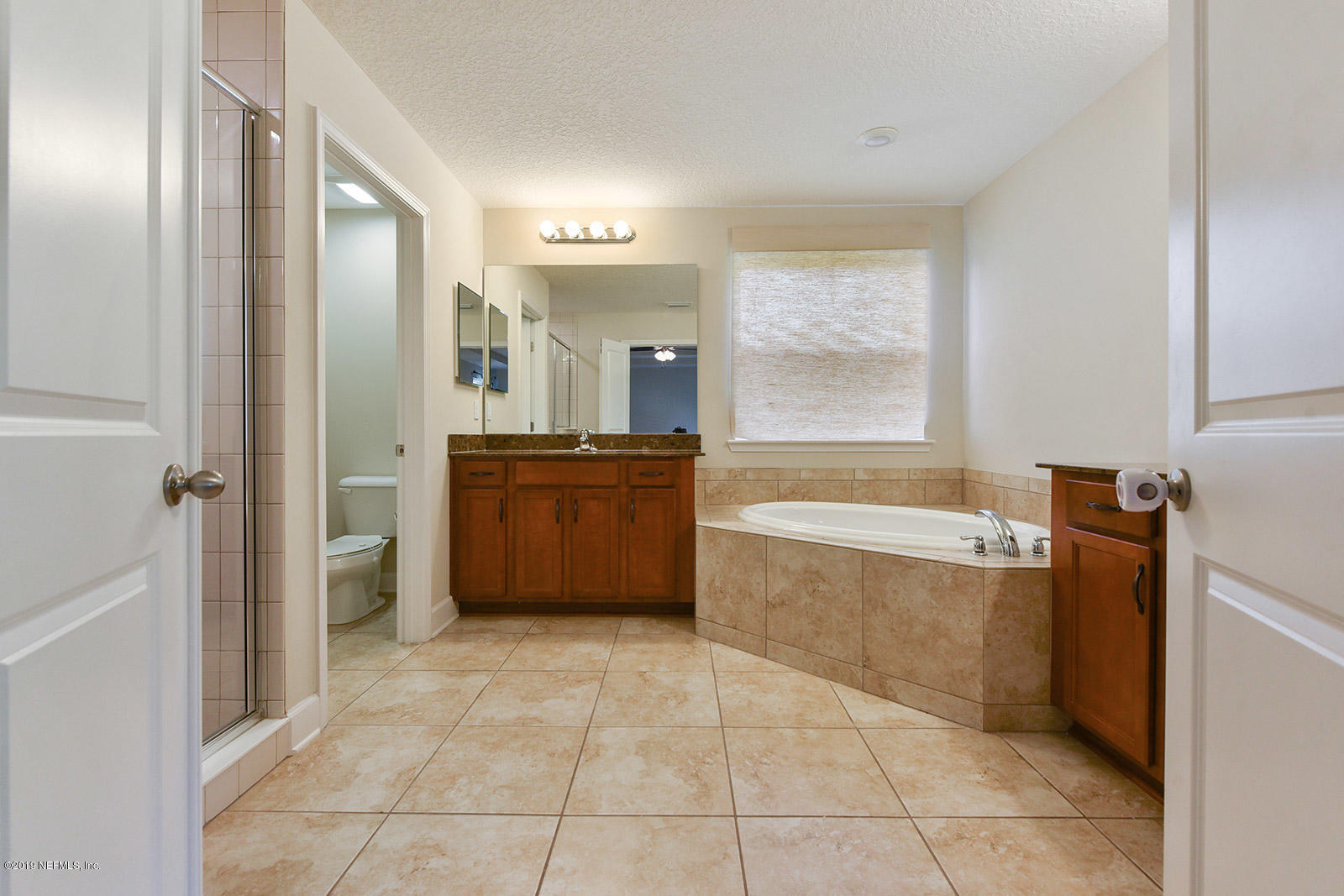 16396 Tisons Bluff Road Jacksonville, FL 32218 - Photo 20 of 30 a spacious bathroom with a tub sink and mirror