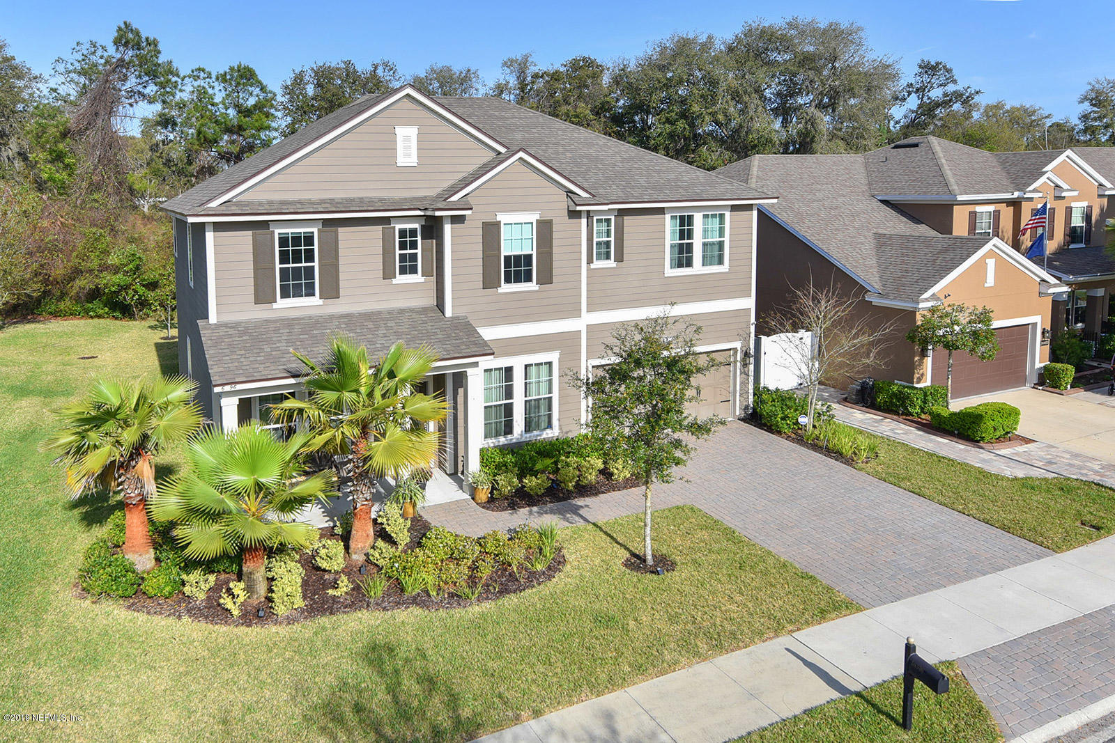 16396 Tisons Bluff Road Jacksonville, FL 32218 - Photo 2 of 30 a view of a white house with a yard and potted plants