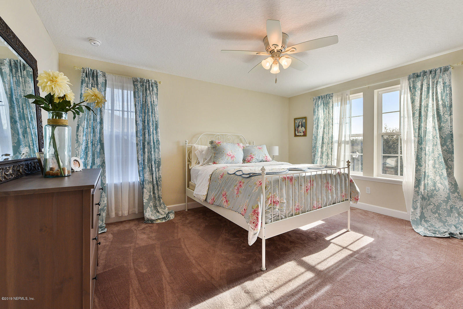 16396 Tisons Bluff Road Jacksonville, FL 32218 - Photo 23 of 30 a bedroom with a bed chandelier and a window