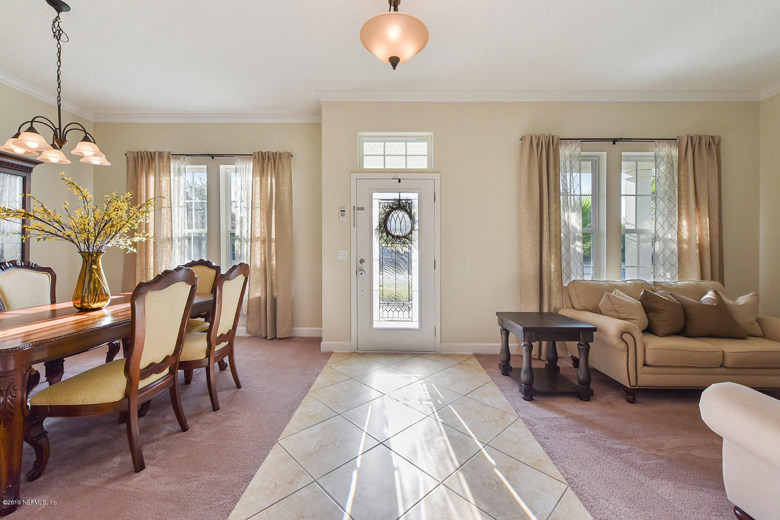 16396 Tisons Bluff Road Jacksonville, FL 32218 - Photo 6 of 30 a living room with furniture a dining table and a large window