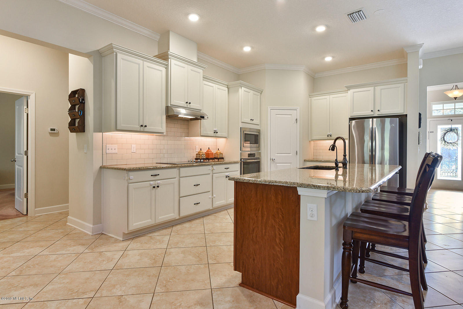 16396 Tisons Bluff Road Jacksonville, FL 32218 - Photo 9 of 30 a kitchen with stainless steel appliances kitchen island granite countertop a stove refrigerator and cabinets