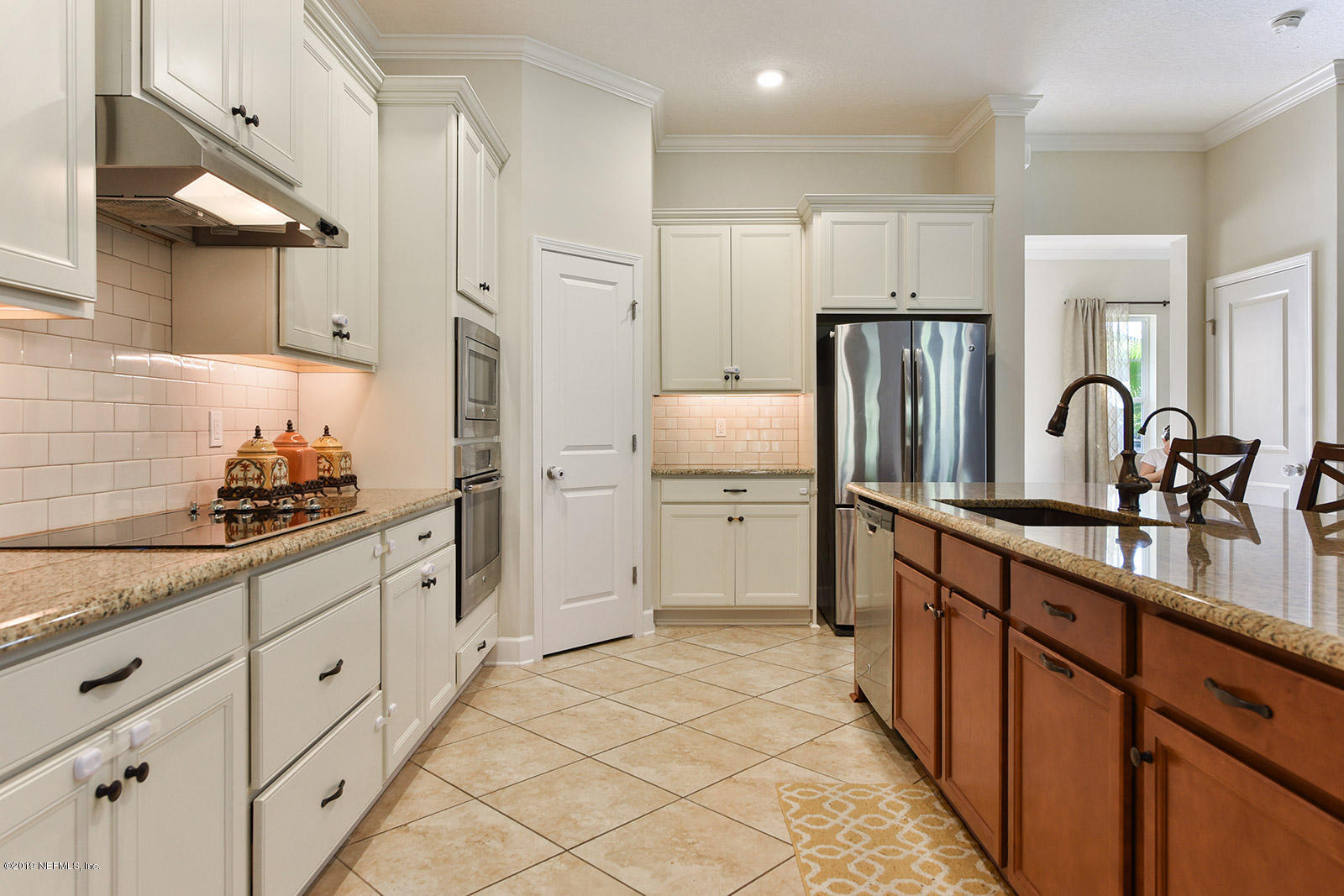 16396 Tisons Bluff Road Jacksonville, FL 32218 - Photo 10 of 30 a kitchen with white cabinets and stainless steel appliances