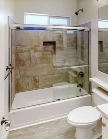 a bathroom with a shower and a toilet