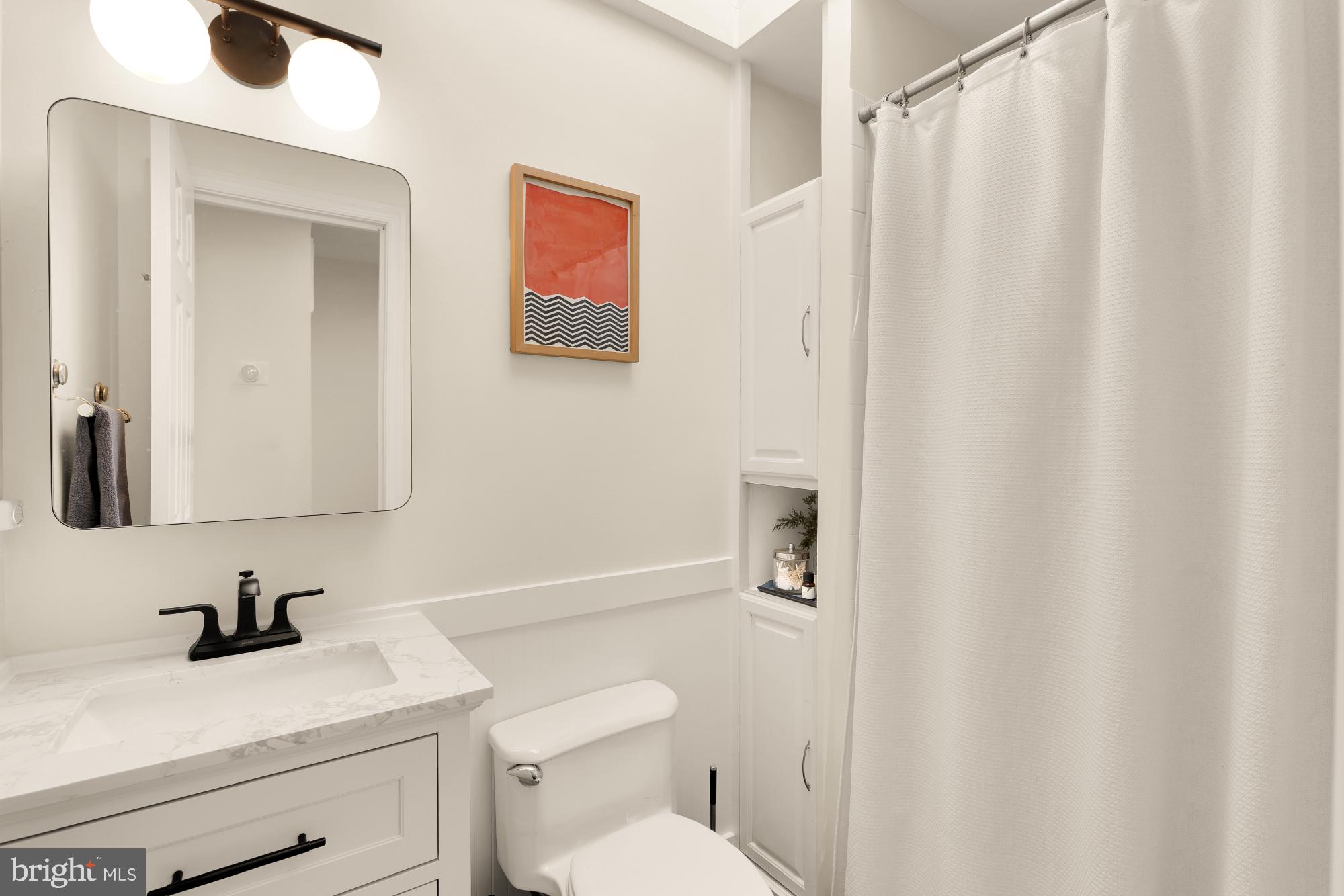 1652 Kalorama Road Northwest Washington, DC 20009 - Photo 14 of 17 a bathroom with a sink a toilet and a mirror