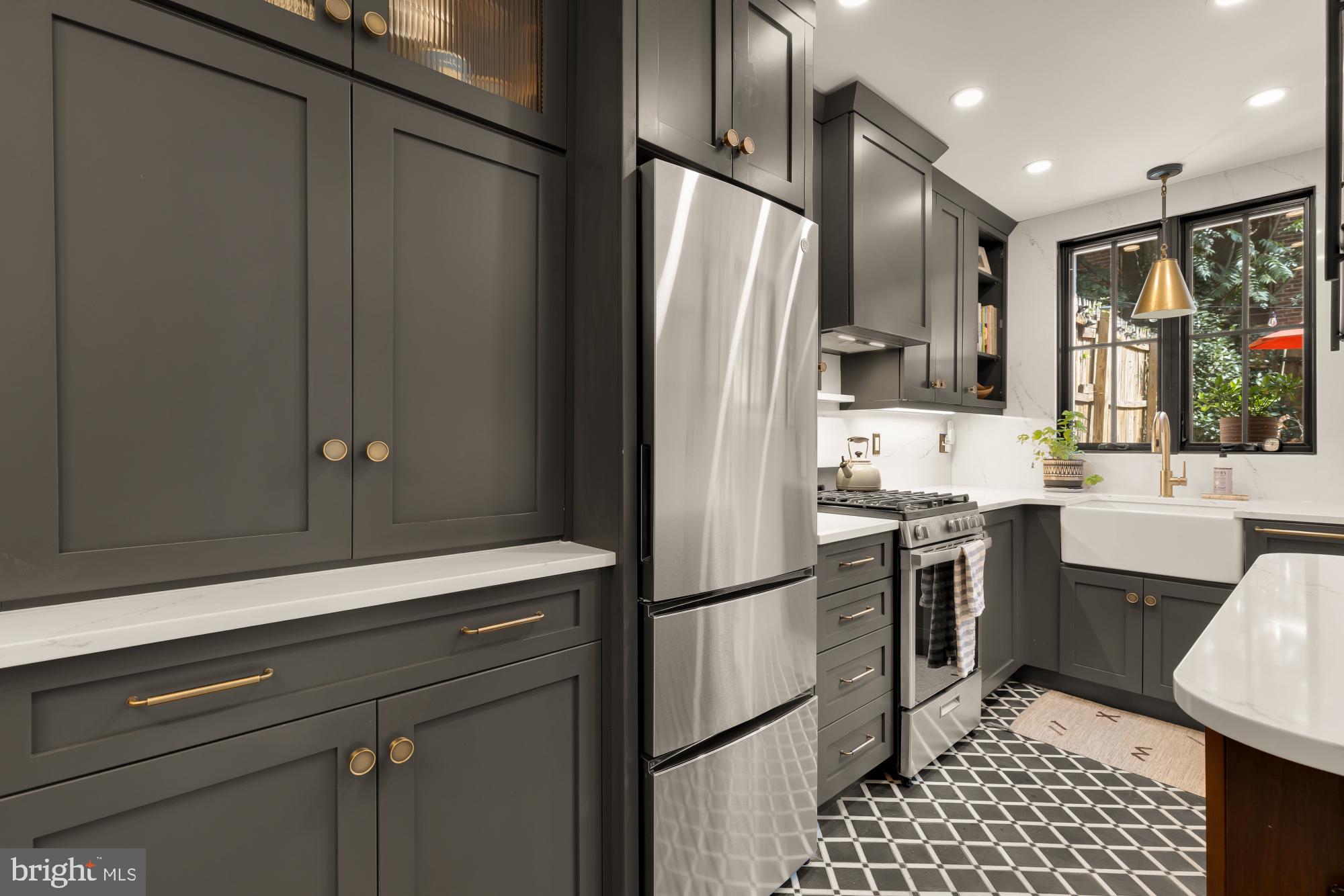 1652 Kalorama Road Northwest Washington, DC 20009 - Photo 3 of 17 a kitchen with stainless steel appliances a refrigerator sink and stove