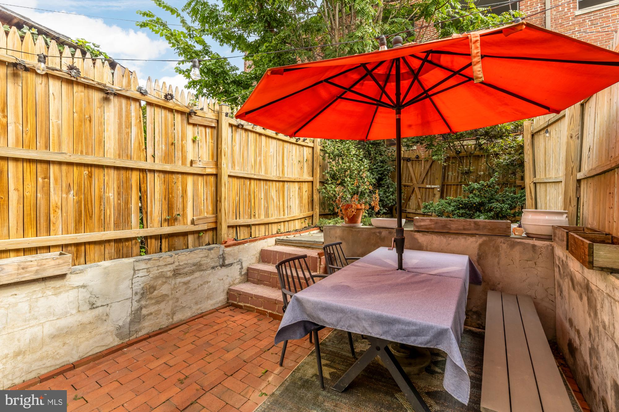 1652 Kalorama Road Northwest Washington, DC 20009 - Photo 7 of 17 an outdoor space with furniture and umbrella