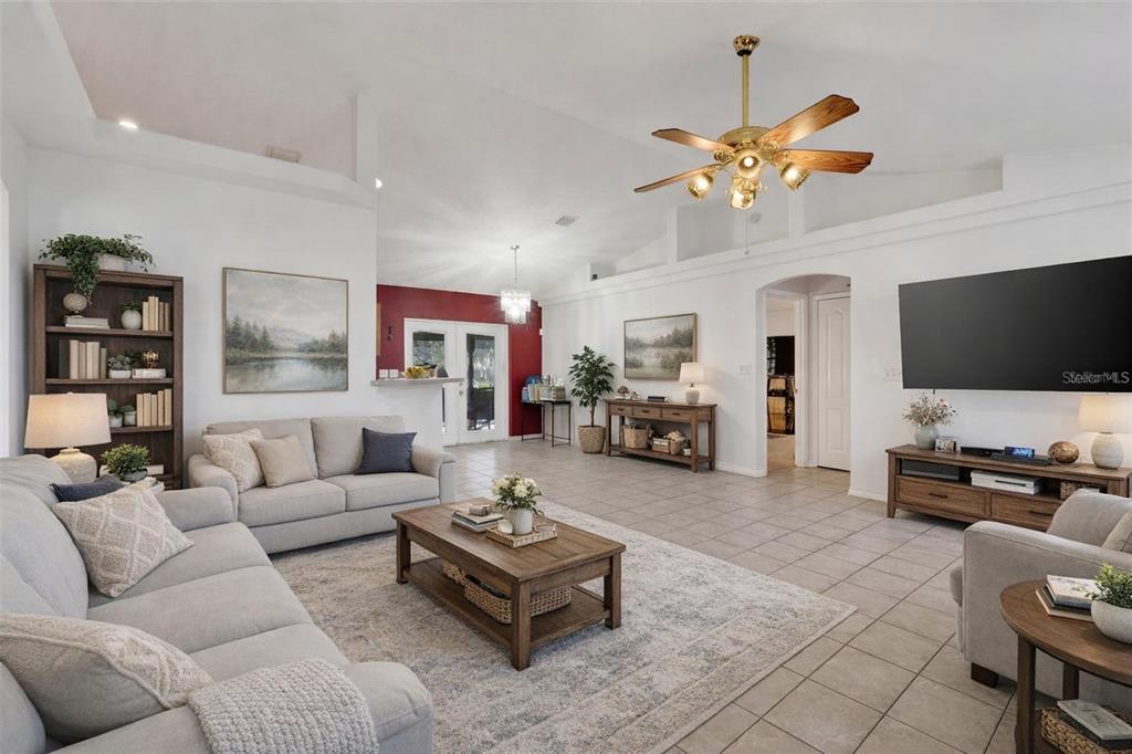 13330 Georgia Avenue Astatula, FL 34705 - Photo 2 of 16 a living room with furniture kitchen view and a flat screen tv