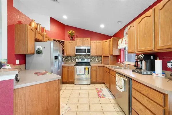 a kitchen with stainless steel appliances a refrigerator sink and cabinets
