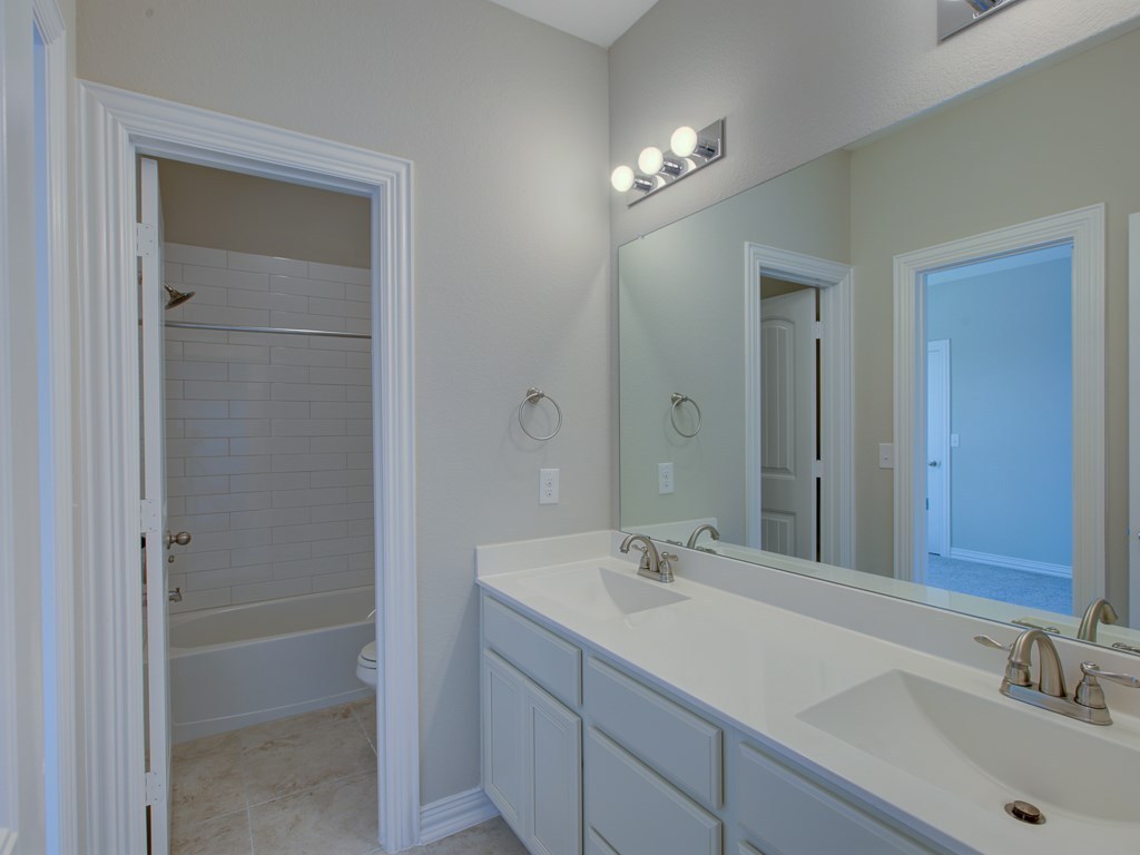 4303 Logan Ridge Drive Cedar Park, TX 78613 - Photo 21 of 24 Dual vanity with white cabinetry and integrated sinks