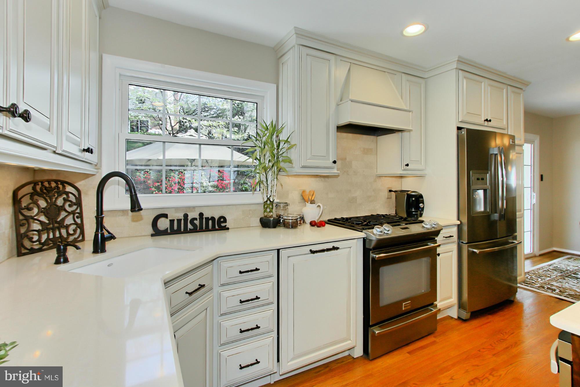7012 Hadlow Drive Springfield, VA 22152 - Photo 12 of 30 a kitchen with stainless steel appliances granite countertop a stove a refrigerator and a sink