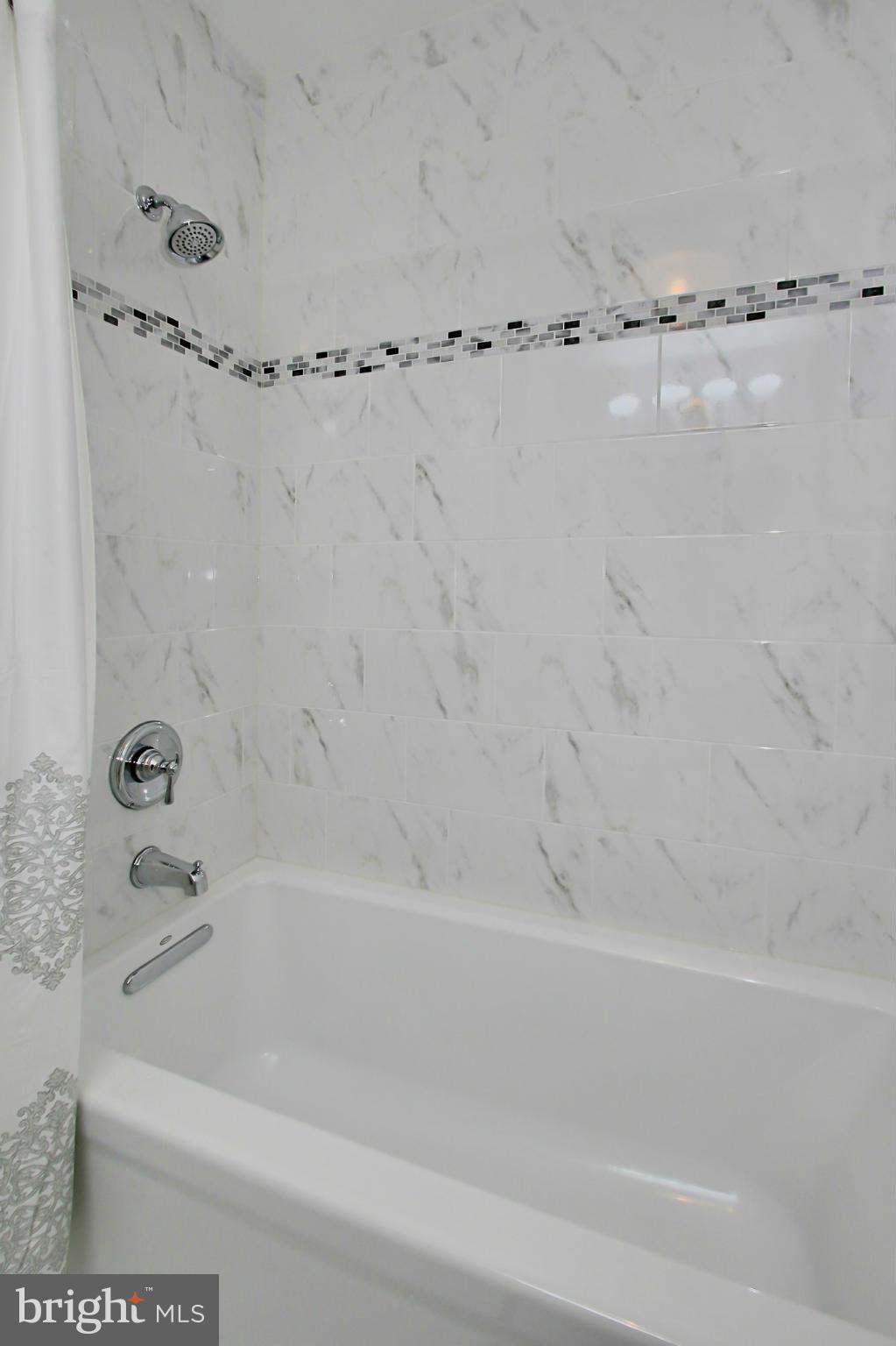 7012 Hadlow Drive Springfield, VA 22152 - Photo 22 of 30 a bathroom with a bathtub and a shower