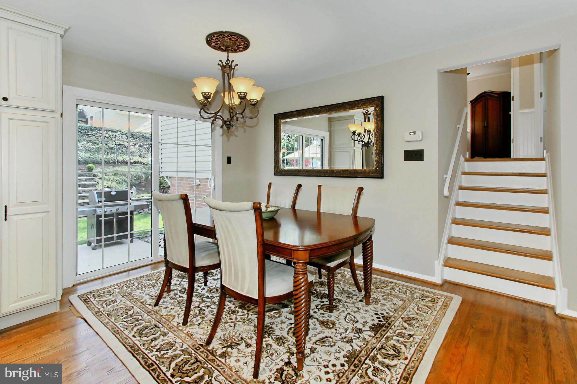7012 Hadlow Drive Springfield, VA 22152 - Photo 8 of 30 a view of a dining room with furniture wooden floor and chandelier