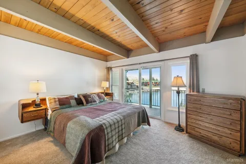 a view of a bedroom with a bed and glass door