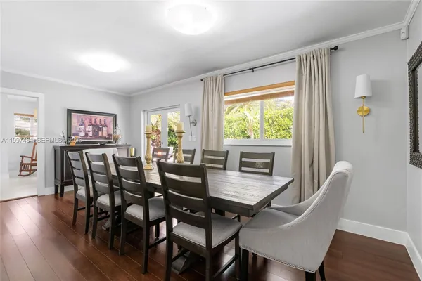 a dining room with furniture and wooden floor