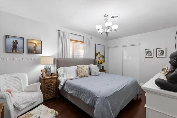 a bedroom with furniture and a window