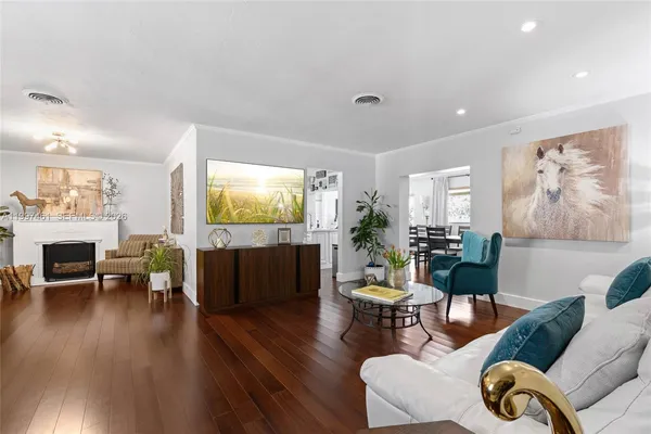 a living room with furniture fireplace and a large window