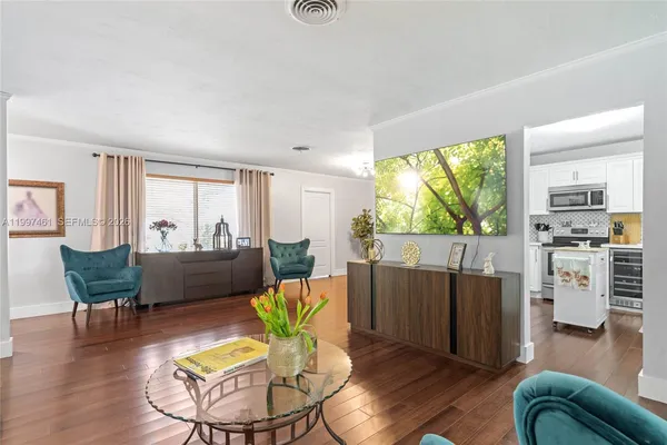 a living room with furniture fireplace and potted plants