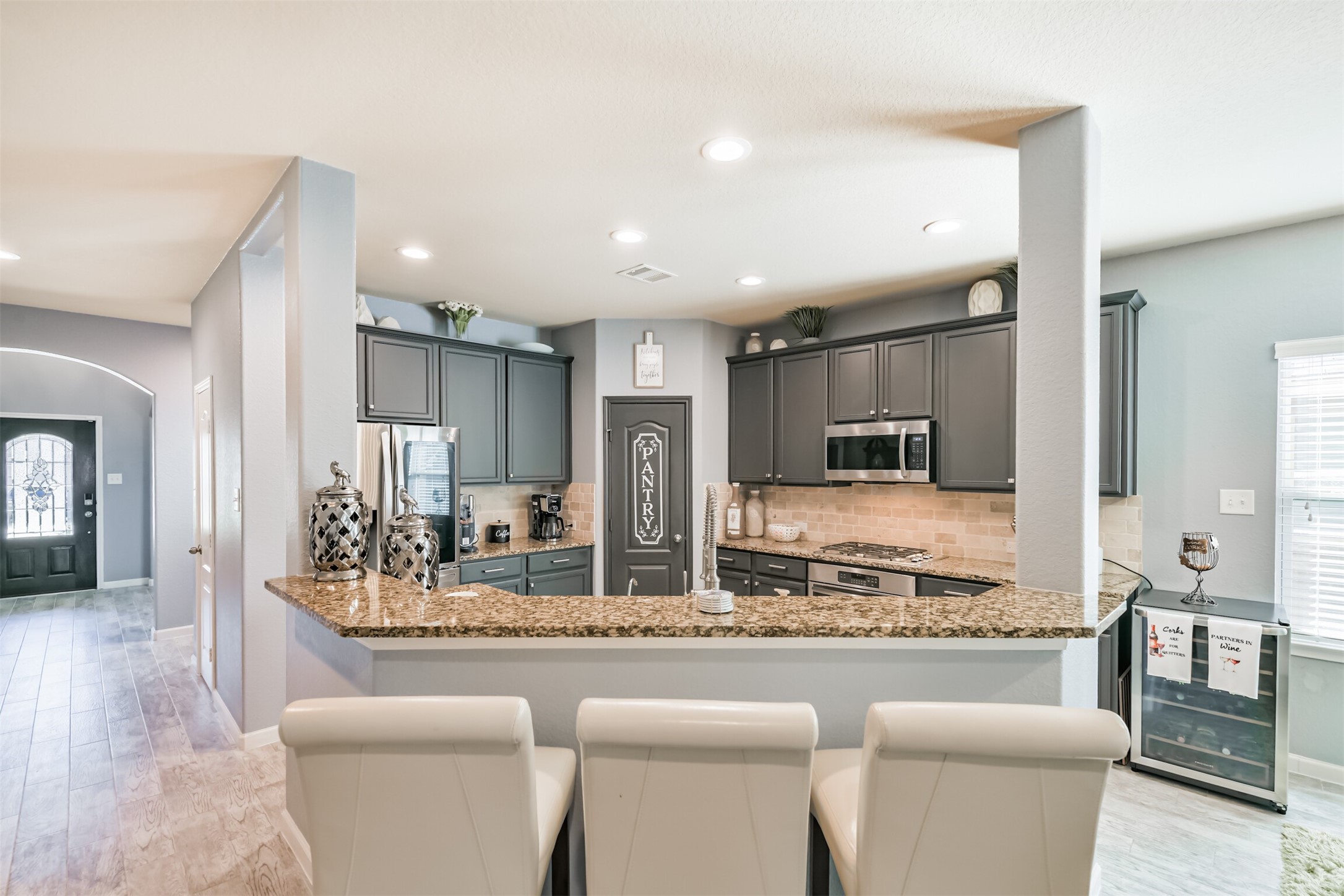 24047 Schults Meadow Lane Spring, TX 77389 - Photo 13 of 47 a living room with stainless steel appliances kitchen island granite countertop a couch and a view of living room